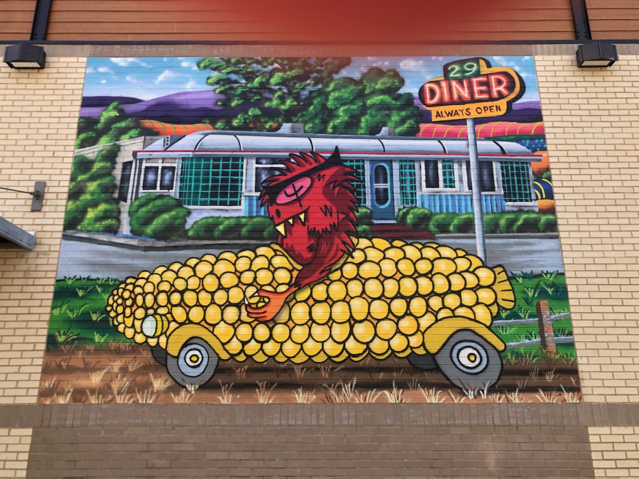 Corn Car driven by a red monster in front of Diner 29